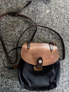 Dooney & Bourke womens Black Nylon Crossbody with Brown Leather Flap